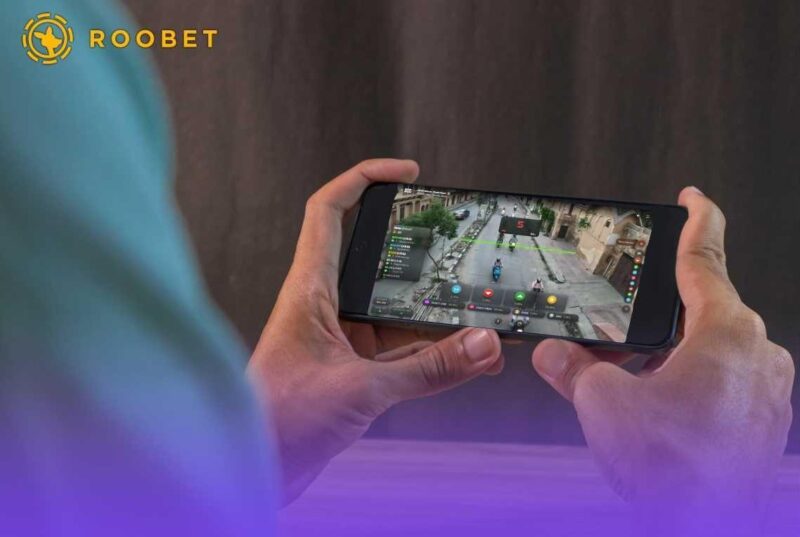 Person holding a phone with Roobet CCTV on it